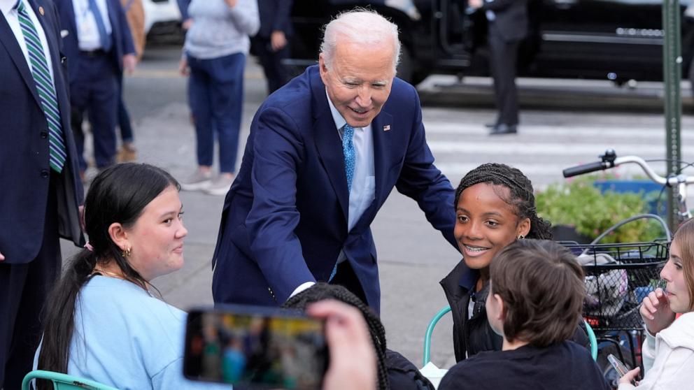 PHOTO: President Joe Biden talks with young patrons after walking out of BMORE LICKS, a homemade ice cream business in Baltimore, Oct. 29, 2024, after speaking the Port of Baltimore.