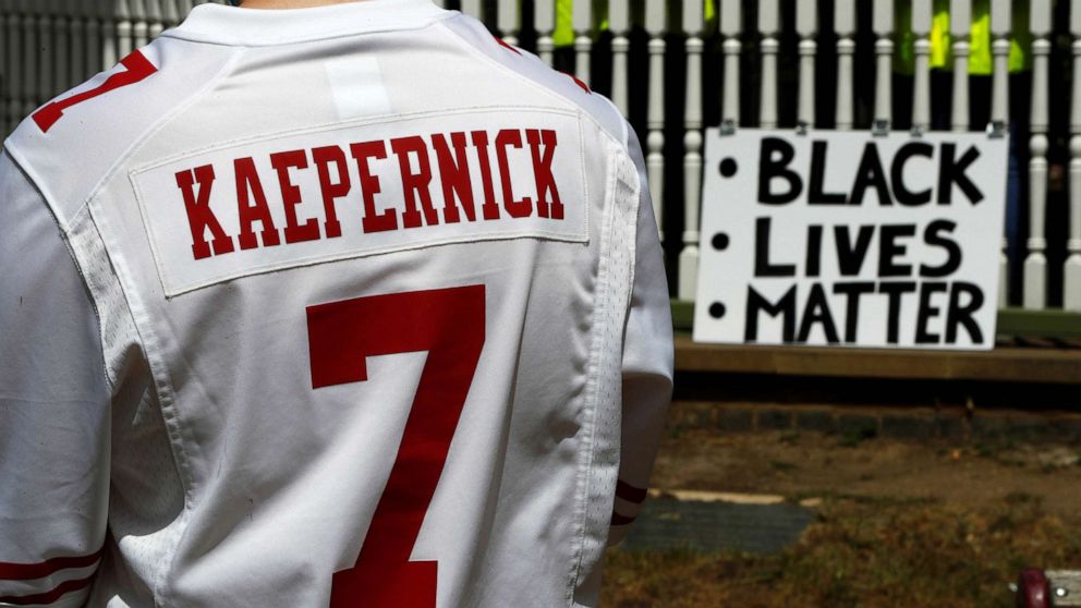 PHOTO:A man wears a jersey of former NFL quarterback Colin Kaepernick ahead of a Black Lives Matter protest in Forbury Gardens in Reading, Britain, June 13, 2020. 