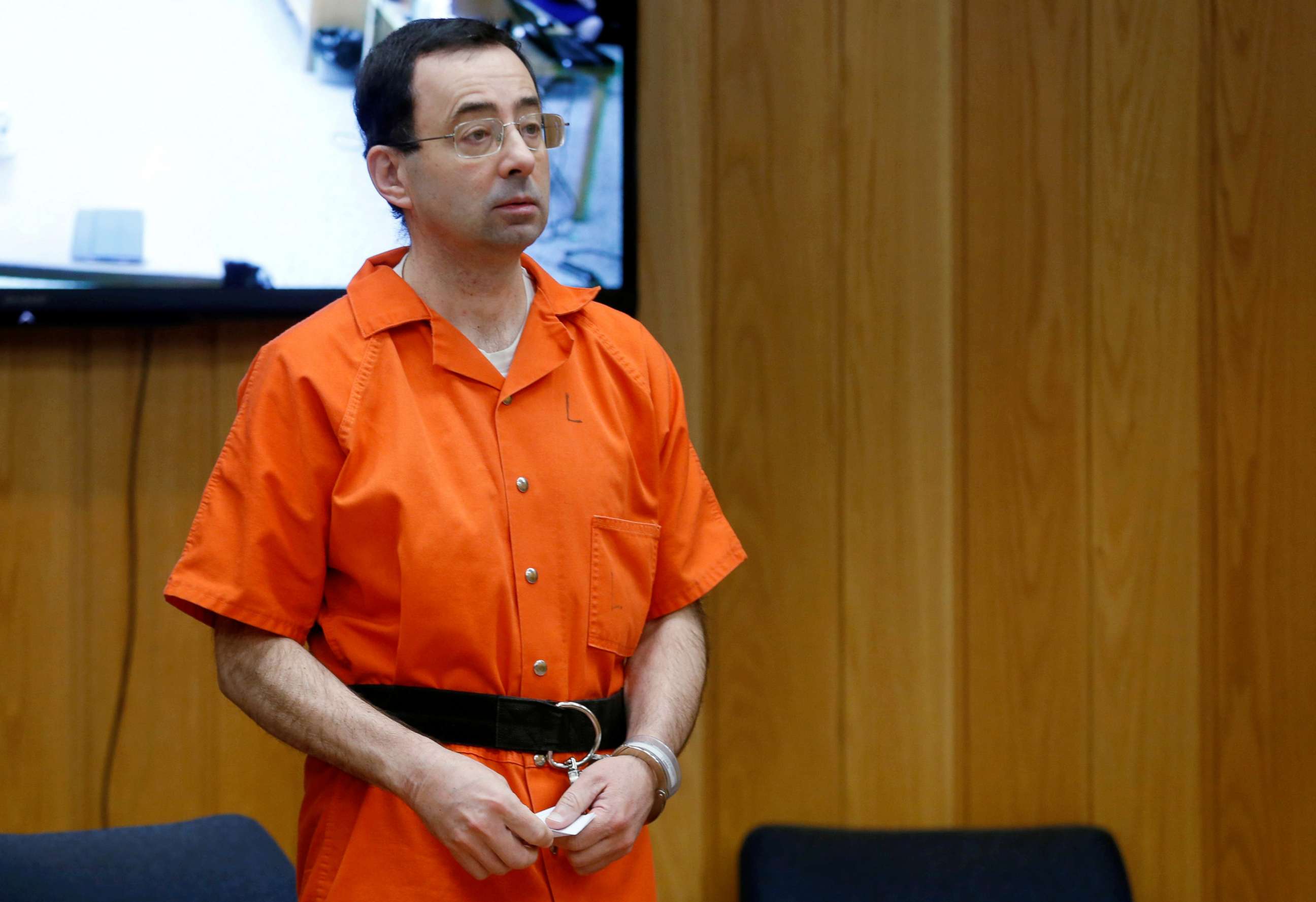 FILE PHOTO: Larry Nassar, a former team USA Gymnastics doctor who pleaded guilty in November 2017 to sexual assault charges, stands in court during his sentencing hearing in the Eaton County Court in Charlotte, Michigan, U.S., Feb. 5, 2018.  