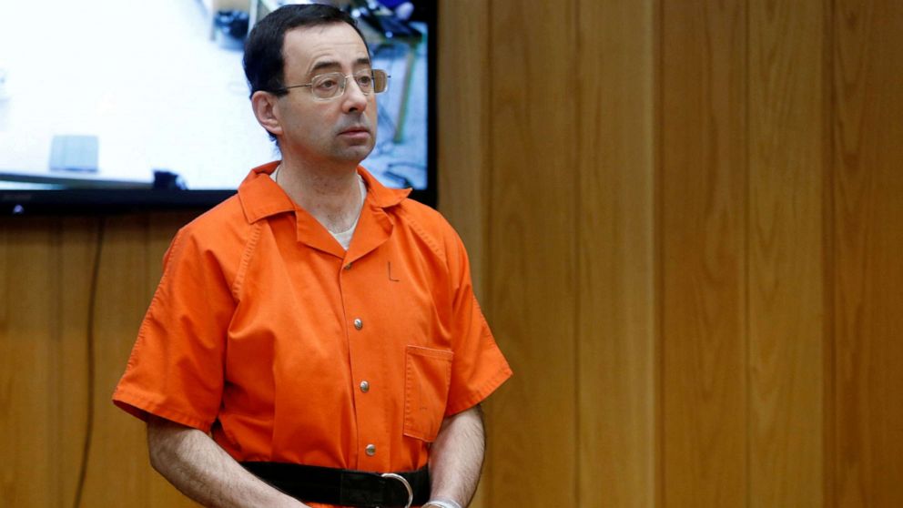 FILE PHOTO: Larry Nassar, a former team USA Gymnastics doctor who pleaded guilty in November 2017 to sexual assault charges, stands in court during his sentencing hearing in the Eaton County Court in Charlotte, Michigan, U.S., Feb. 5, 2018.