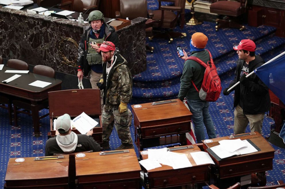 PHOTO: WASHINGTON, DC - JANUARY 06: Protesters enter the Senate Chamber on January 06, 2021 in Washington, DC. Congress held a joint session today to ratify President-elect Joe Biden's 306-232 Electoral College win over President Donald Trump. 
