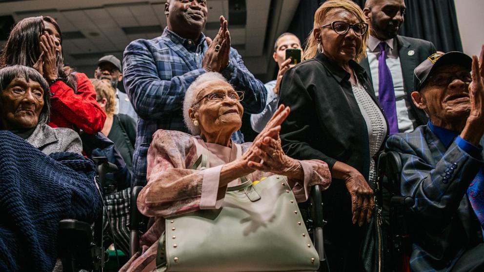 PHOTO: Survivors Lessie Benningfield Randle, Viola Fletcher, and Hughes Van Ellis sing together at the conclusion of a rally during commemorations of the 100th anniversary of the Tulsa Race Massacre on June 1, 2021 in Tulsa.