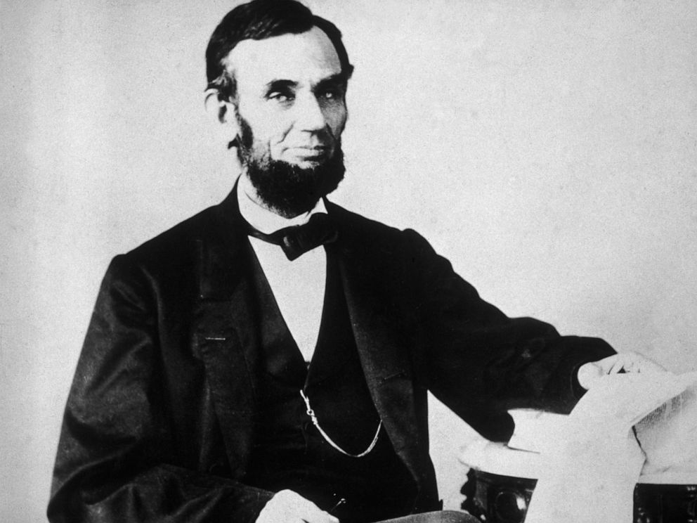 PHOTO: The 16th American president, Abraham Lincoln (1809 - 1865), sitting and leafing through documents, Washington, D.C.