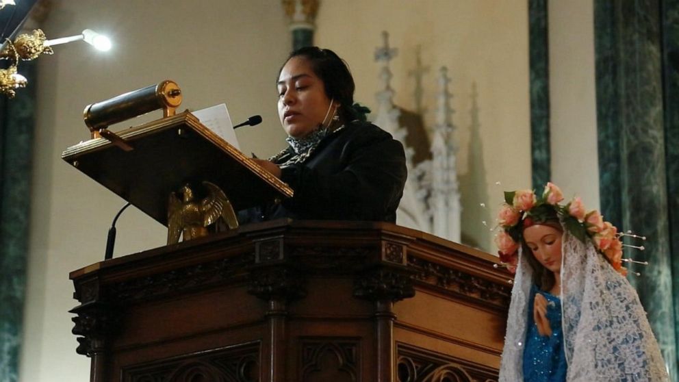 PHOTO: Lucero Martinez Felipe speaks during a funeral mass for 25 members of her community, including her mother. 