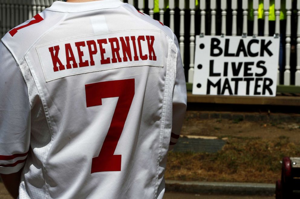 PHOTO: A man wears a jersey of former NFL quarterback Colin Kaepernick ahead of a Black Lives Matter protest in Forbury Gardens in Reading, Britain June 13, 2020. 