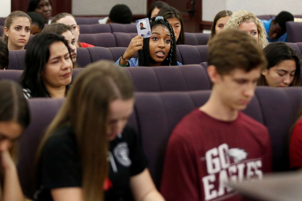 PHOTO: Tyra Hemans, a senior from Marjory Stoneman Douglas (MSD) High School, holds a photo of her friend Joaquin Oliver, who died during last weeks mass shooting on campus, as she speaks with the Florida Senate, in Tallahassee, Fla., Feb. 21, 2018. 