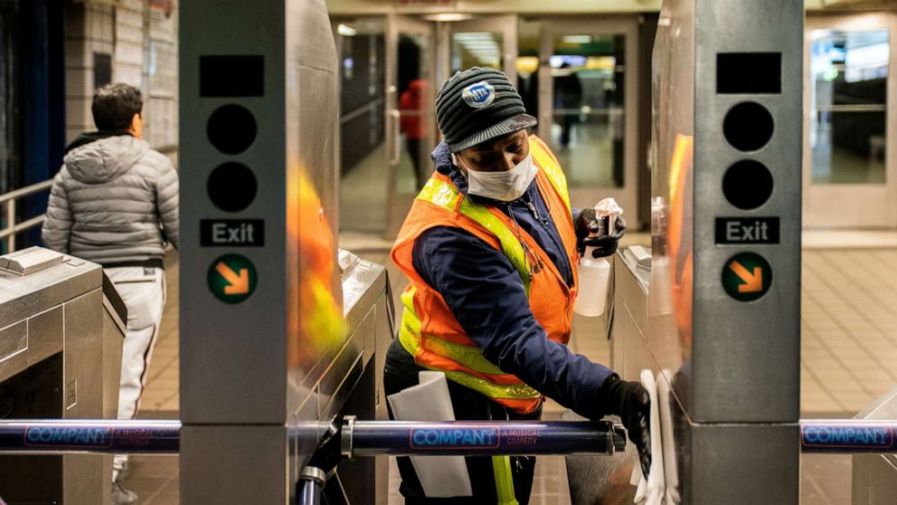 PHOTO: An MTA transit worker cleans a nearly empty Times Square-42nd Street subway station following the outbreak of novel coronavirus, in New York City, March 16, 2020. 