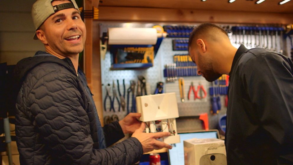 PHOTO: YouTuber Mark Rober and "Nightline's" Ashan Singh inside Rober's San Franscisco Bay Area workshop, where Rober shows Singh a version of a glitter bomb he used to prank a package thief. 