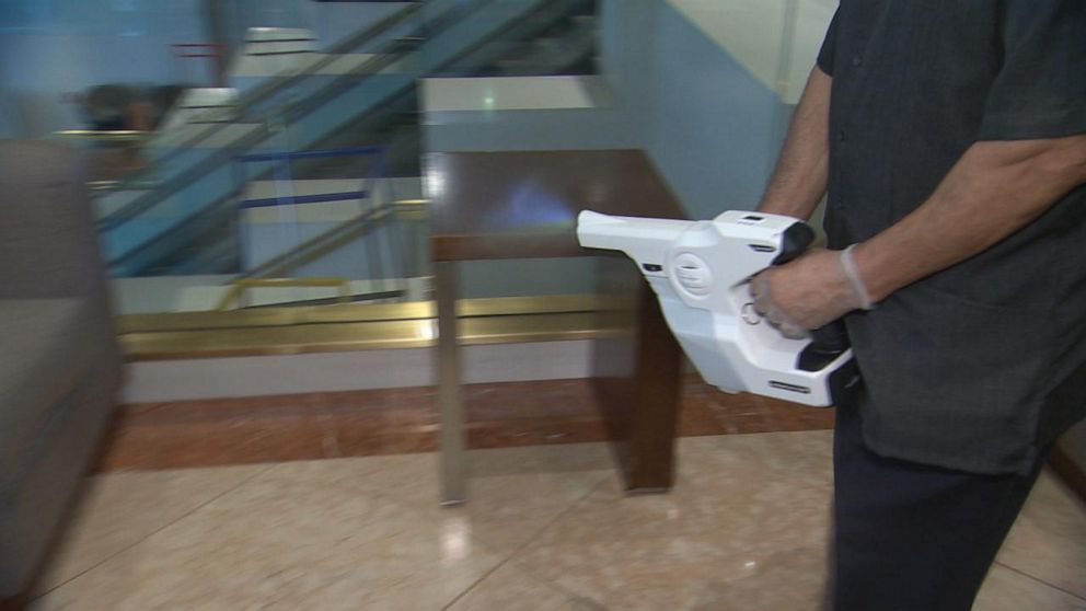 PHOTO: Marriott employee at Marriott Brooklyn Bridge uses an electrostatic sprayer to sanitize common areas in the hotel.