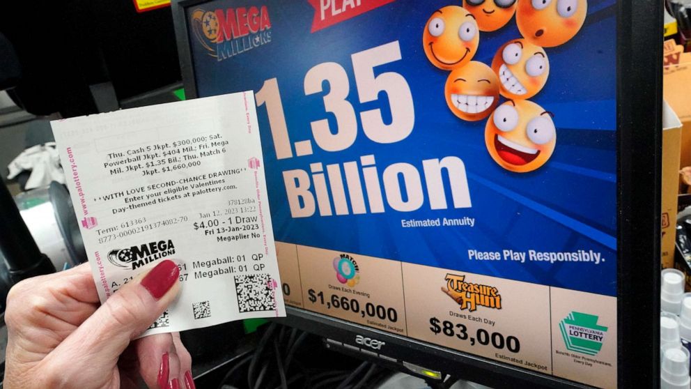 PHOTO: A customer at the Cranberry Super Mini Mart shows her Mega Millions ticket, Jan. 12, 2023, in Cranberry, Pa.