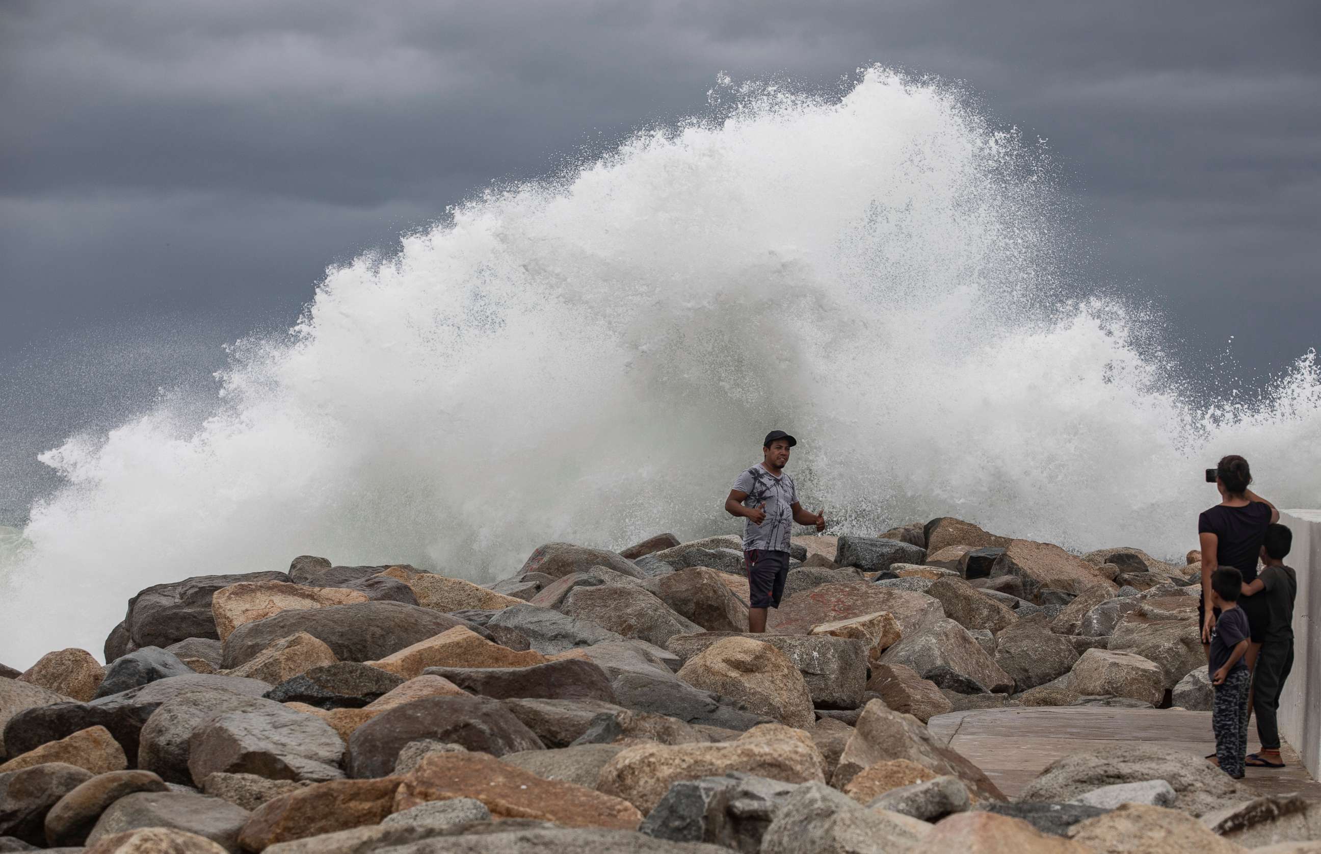 PHOTO: A tourist poses for a photo in front breaking waves before the expected arrival of Hurricane Lorena, in Los Cabos, Mexico, Friday, Sept. 20, 2019. 