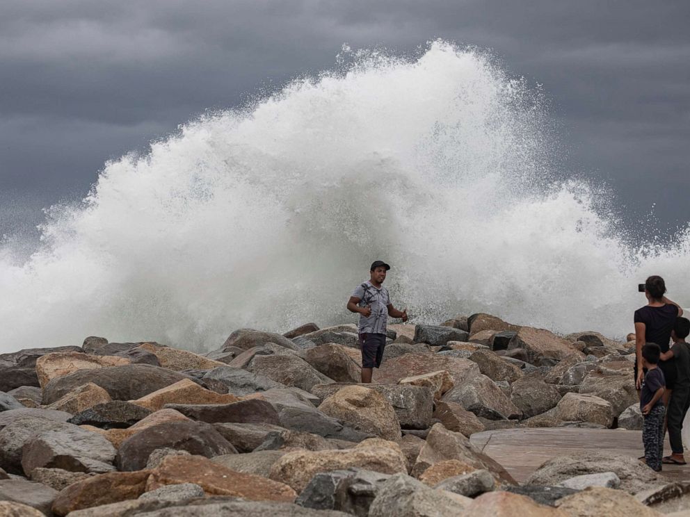 PHOTO: A tourist poses for a photo in front breaking waves before the expected arrival of Hurricane Lorena, in Los Cabos, Mexico, Friday, Sept. 20, 2019.