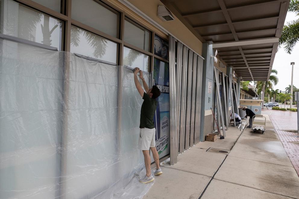 PHOTO: People board up businesses as Hurricane Milton approaches Fort Myers, Florida, on Oct. 8, 2024.