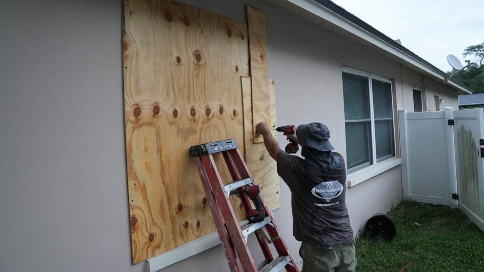 PHOTO: A resident boards up his windows ahead of Hurricane Milton's expected mid-week landfall, in Palm Harbor, Fla., Oct. 6, 2024. 