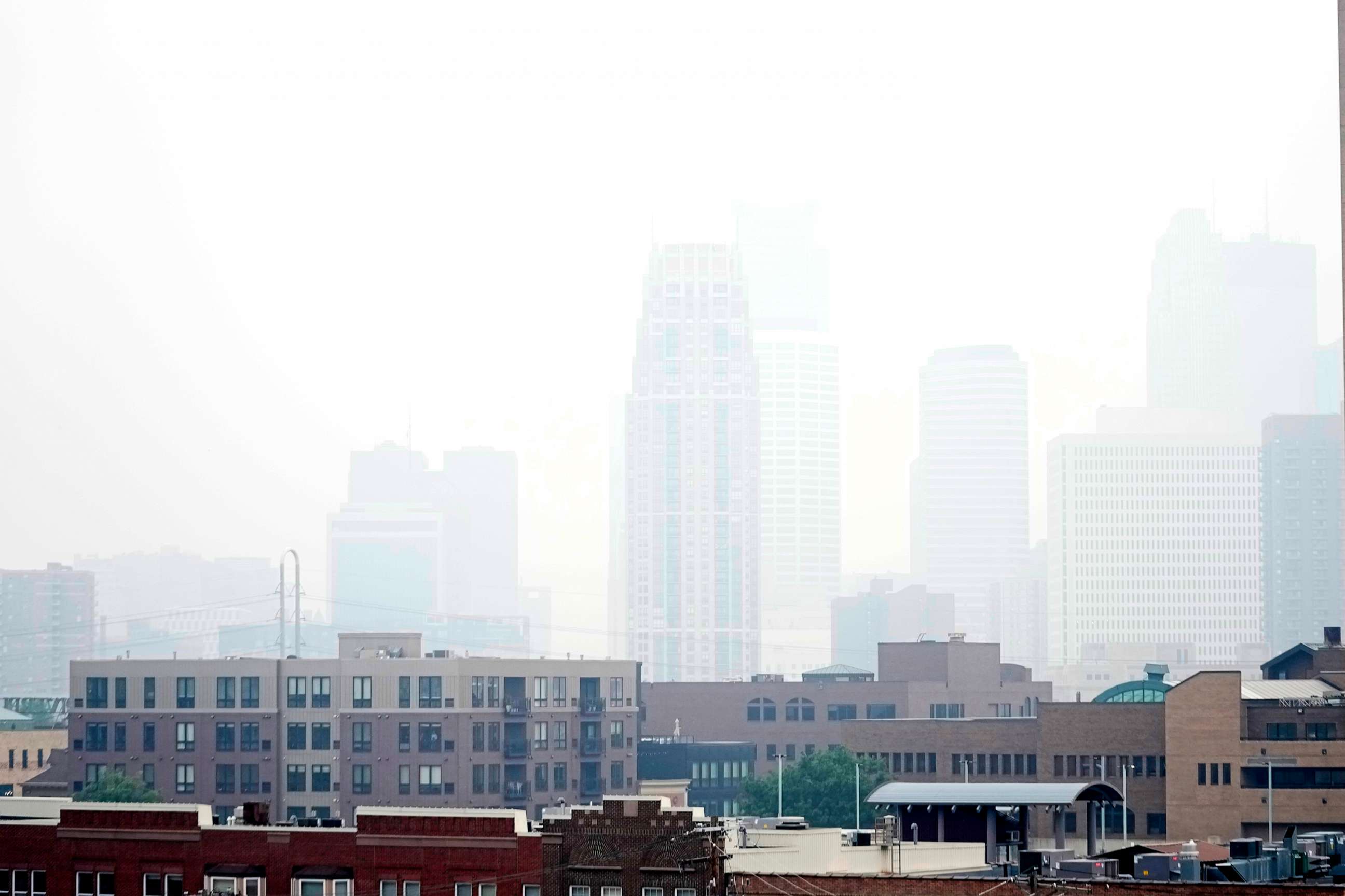 PHOTO: Haze envelopes the Minneapolis skyline from smoke drifted over from the wildfires in Canada, June 14, 2023, in Minneapolis.