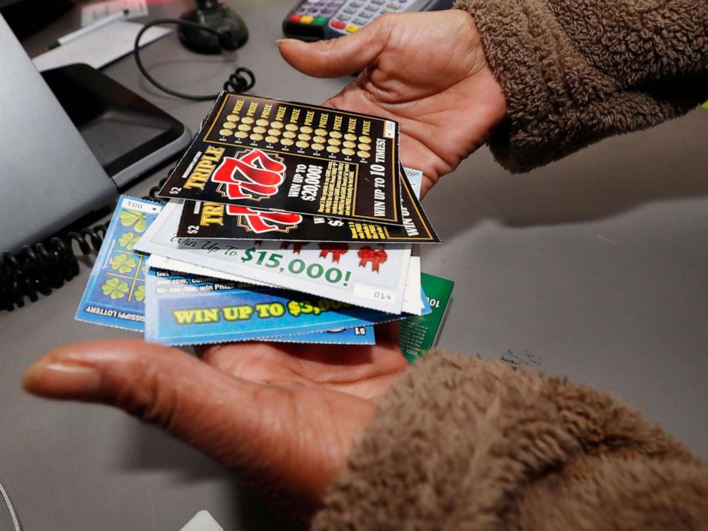 PHOTO: A customer shows her scratch-off tickets after making an early morning purchase from at a Jackson. Miss. RaceWay store, Nov. 25, 2019. Licensed lottery retailers in the state began selling tickets Monday. 