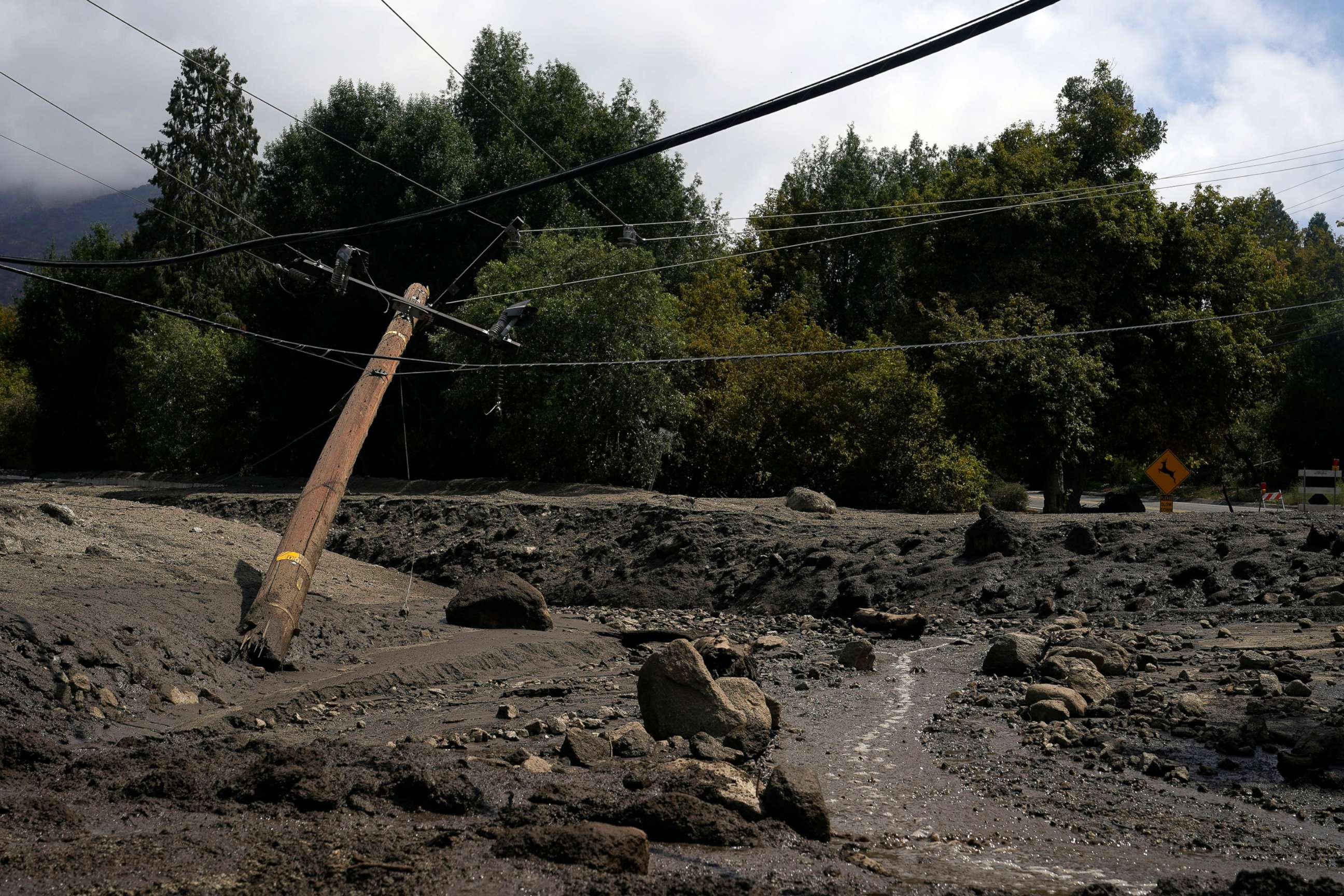 PHOTO: Electric poles are seen half-fallen in the aftermath of a mudslide, Sept. 13, 2022, in Oak Glen, Calif. 