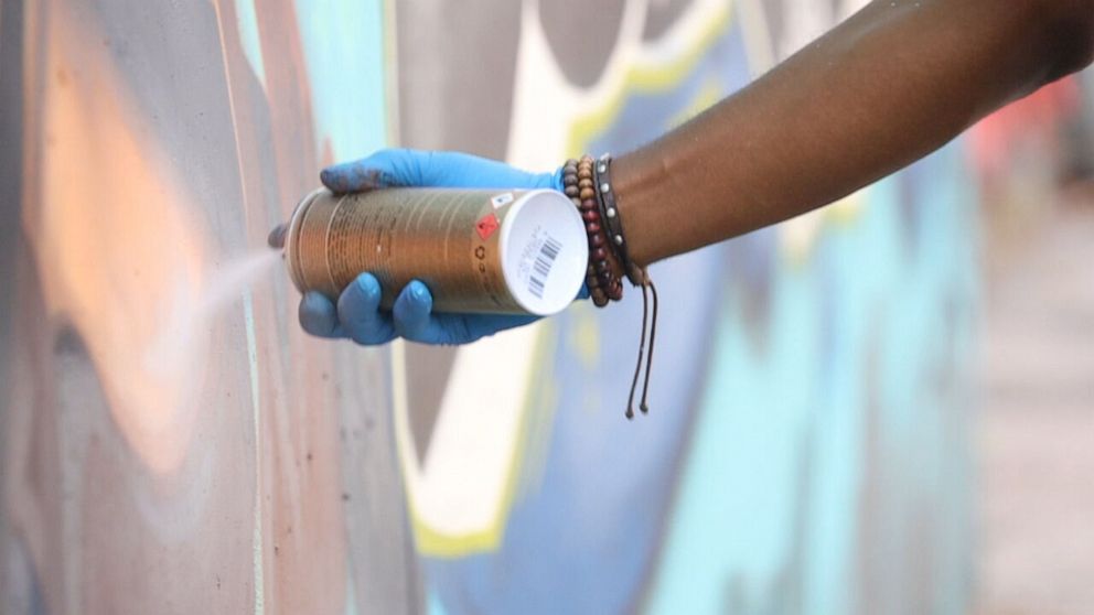 PHOTO: Vince Ballentine, a New York City-based artist, paints a mural of Elijah McClain.