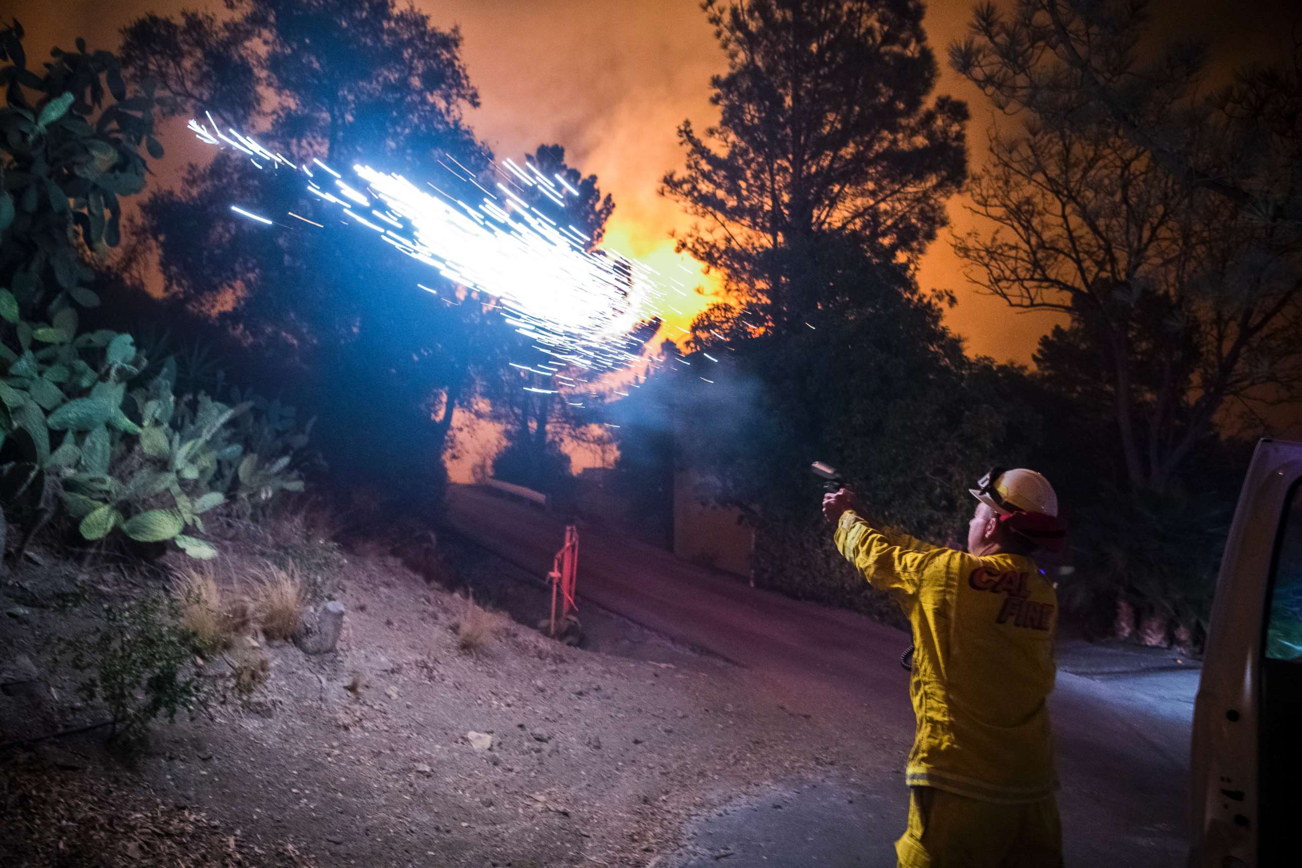 PHOTO: Cal Fire battalion chief and strike team leader Gino DeGraffenreid fires off flares to start a backburn to protect homes on Dec. 11, 2017 in Toro Canyon, Calif., at the Thomas Fire. 