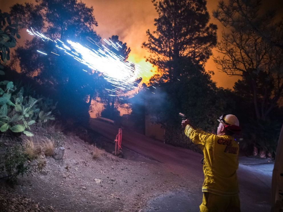 PHOTO: Cal Fire battalion chief and strike team leader Gino DeGraffenreid fires off flares to start a backburn to protect homes on Dec. 11, 2017 in Toro Canyon, Calif., at the Thomas Fire.