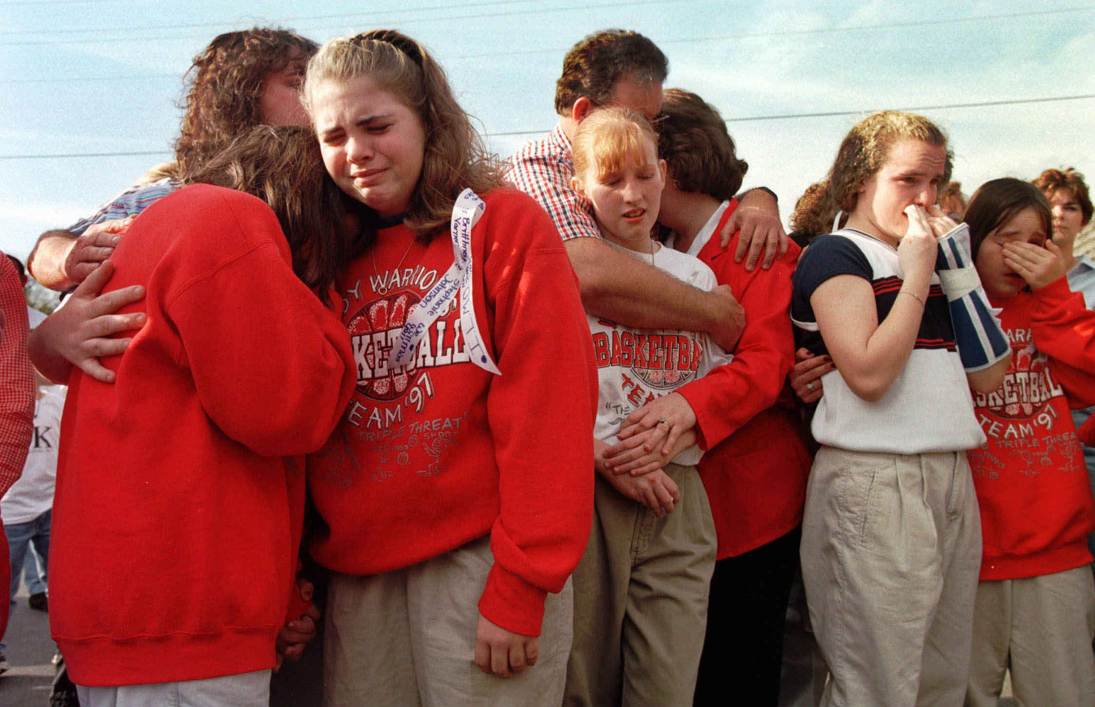 PHOTO: Westside Middle School students gathered in the parking lot of a radio station, March 26, 1998, to hear a tribute song to the children who died in a shooting at the school near Jonesboro, Ark. 