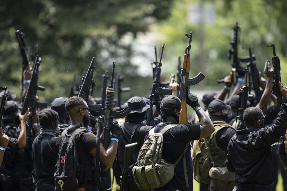 PHOTO: Members of NFAC hold up their firearms before a march on July 25, 2020, in Louisville, Ky. The group is marching in response to the killing of Breonna Taylor.