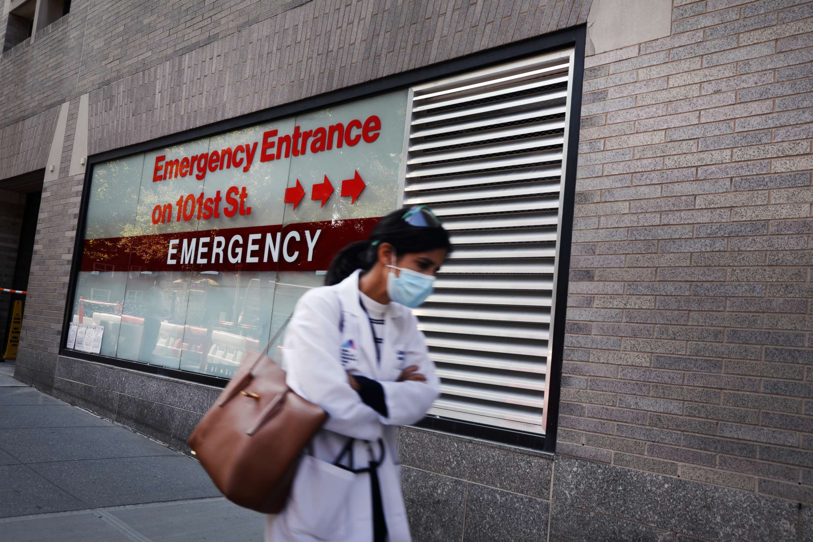 PHOTO: NEW YORK, NEW YORK - SEPTEMBER 22: A person walks past an "Emergency Entrance" sign at Mount Sinai Hospital in Manhattan, which has treated hundreds of COVID-19 patients since March, on September 22, 2020 in New York City. 