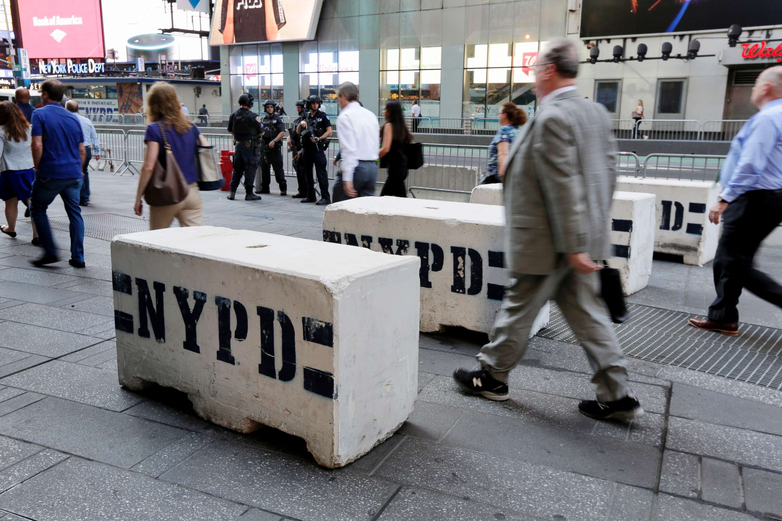 PHOTO: Pedestrians navigate concrete safety barriers in New York Times Square, May 19, 2017.