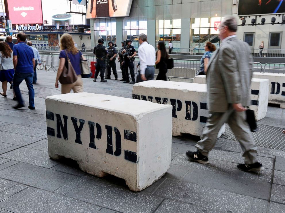 PHOTO: Pedestrians navigate concrete safety barriers in New York Times Square, May 19, 2017.