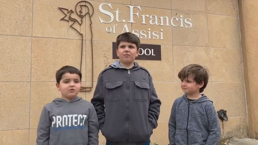 PHOTO: Nathan Herber, 6, pictured with his twin brother Justin and his big brother Grant at their school in Rochester, Minnesota.