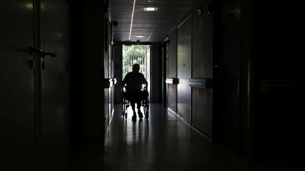 PHOTO: A resident on a wheelchair is seen in a corridor at "Les Figuiers" retirement home (Ehpad - Housing Establishment for Dependant Elderly People) amid the coronavirus disease (COVID-19) outbreak in Villeneuve-Loubet, France, September 16, 2020.  