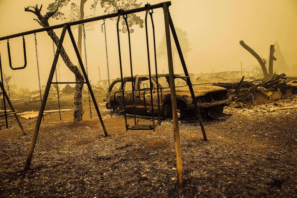 PHOTO: TOPSHOT - A charred swing set and car are seen after the passage of the Santiam Fire in Gates, Oregon, on September 10, 2020.