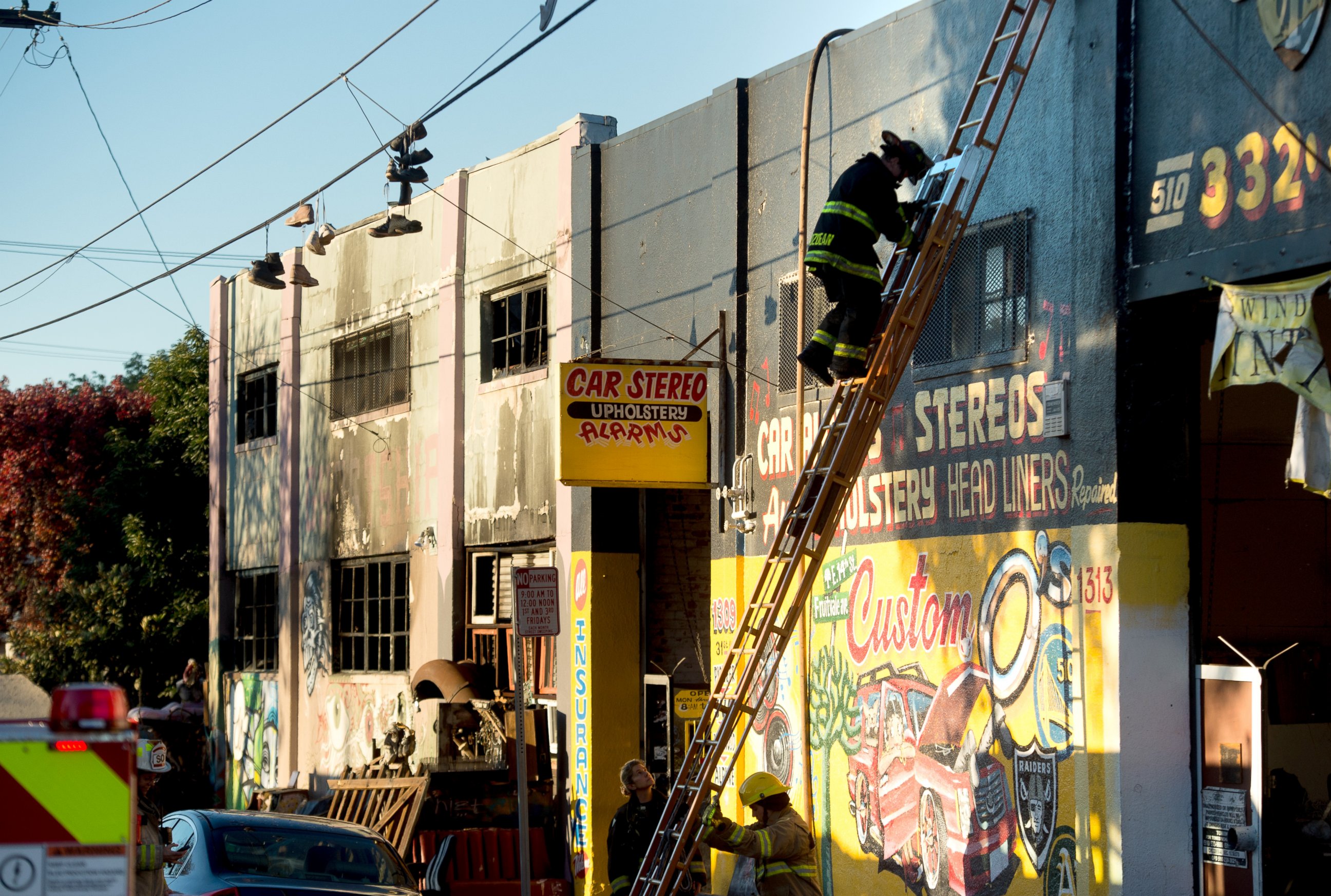 PHOTO: A firefighter climbs down a ladder at the scene of a fire that killed at least nine people on 31st St., Dec. 3, 2016, in Oakland, California. 