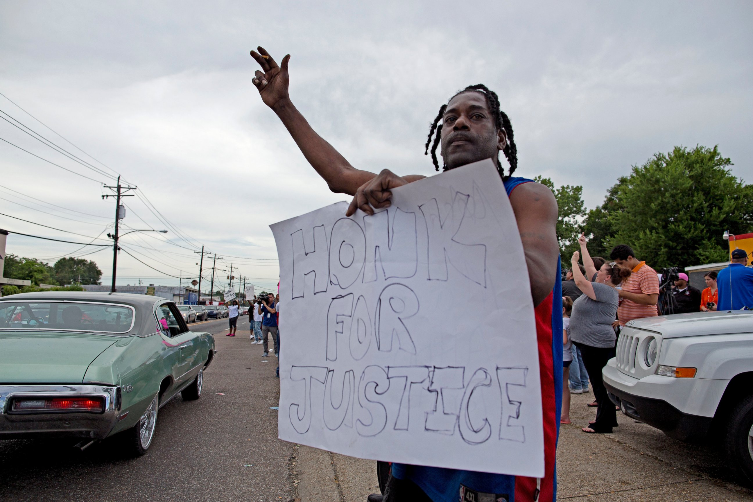 PHOTO: Protesters outside the Triple S convenience store hold signs July 6, 2016, supporting justice for Alton Sterling, a black man who was shot and killed there by Baton Rouge Police officers. 