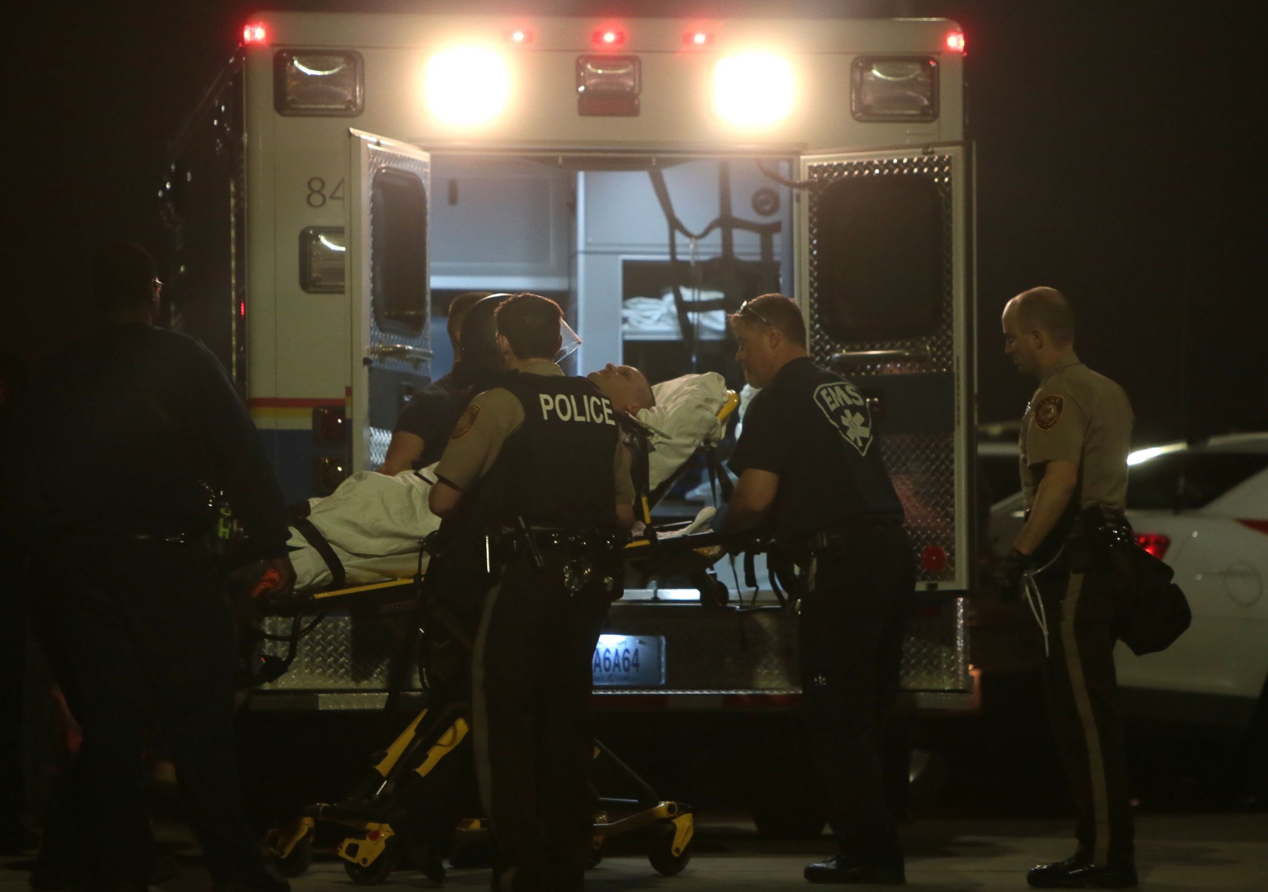 PHOTO: Paramedics load one of two police officer who were shot while standing guard in front of the Ferguson Police Station during a protest, March 12, 2015.  