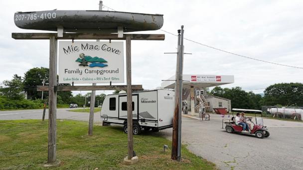 Campers ride a golf cart to the Mic Mac Cove Campground, July 9, 2025, in Union, Maine, where police have used the campground to access Crawford Pond to investigate the murder of a woman last seen paddleboarding on the pond. 