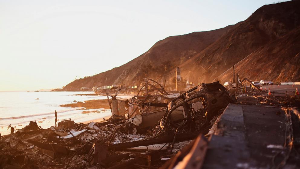 PHOTO: A burned car is seen among the wreckage of a home destroyed by the Palisades Fire, on Jan. 14, 2025, in Malibu, California.