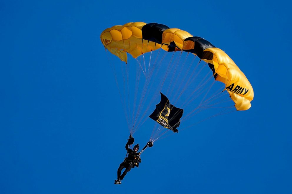 PHOTO: The U.S. Army Parachute Team the Golden Knights descend into National Park before a baseball game between the Washington Nationals and the Arizona Diamondbacks, April 20, 2022, in Washington, D.C.