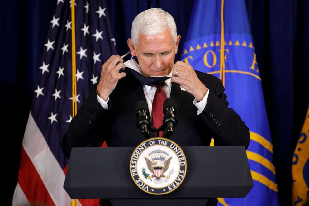 PHOTO: Vice President Pence removes his mask as he arrives at the podium to speak to the Commissioned Corps of the U.S. Public Health Service at their headquarters in Rockville, Md., June 30, 2020. 