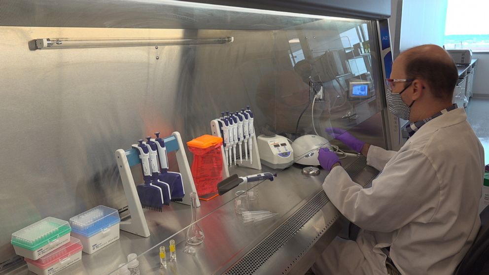PHOTO: A technician inspects vials of coronavirus disease (COVID-19) vaccine candidate BNT162b2 at a Pfizer manufacturing site in manufacturing site in St. Louis, Missouri, U.S. in an undated photograph.   