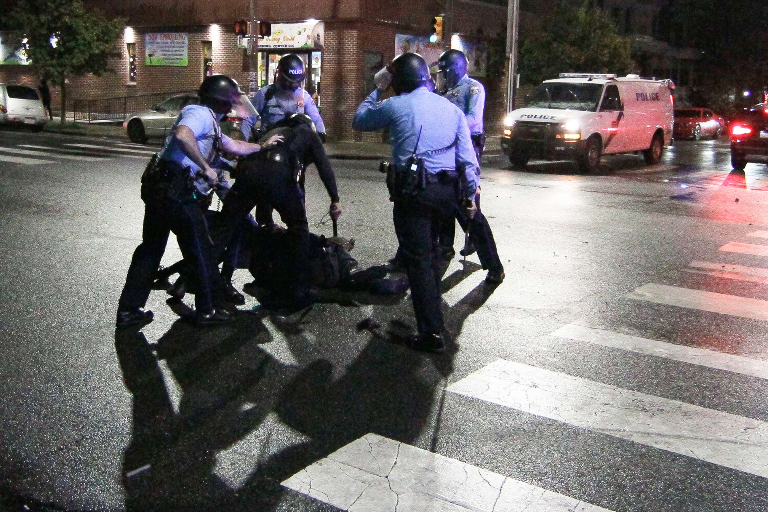 PHOTO: Police surround a man after chasing him down during a violent protest after police shot and killed a 27-year-old Black, Oct. 27, 2020.