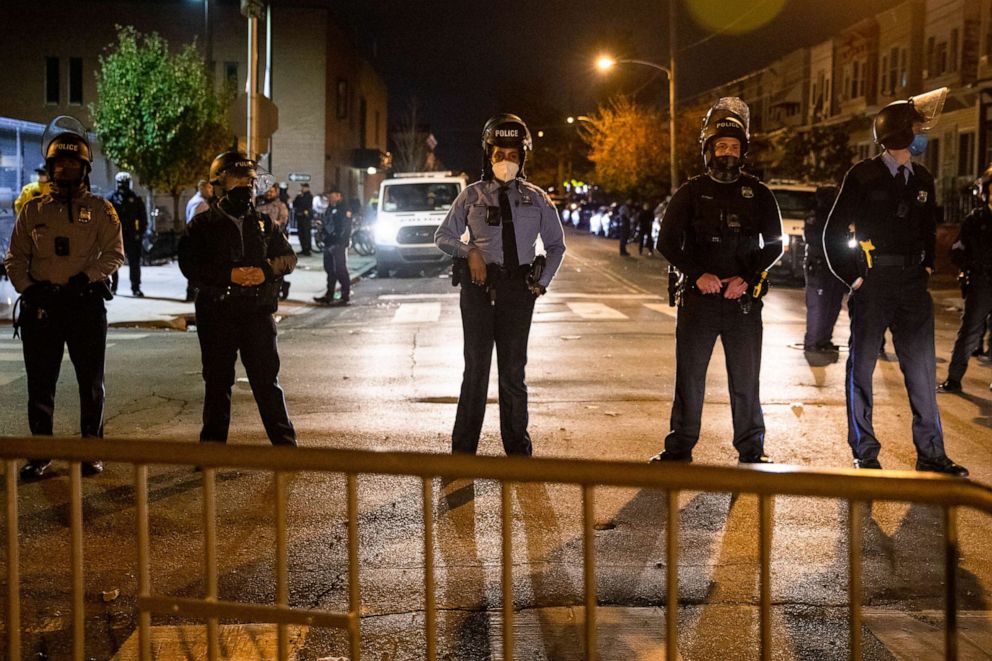 PHOTO: TOPSHOT - Police line up to protect the 18th Police Precinct after the city imposed a 9pm curfew in Philadelphia, October 28, 2020, following two nights of protesting and unrest after the fatal shooting of Walter Wallace Jr. 