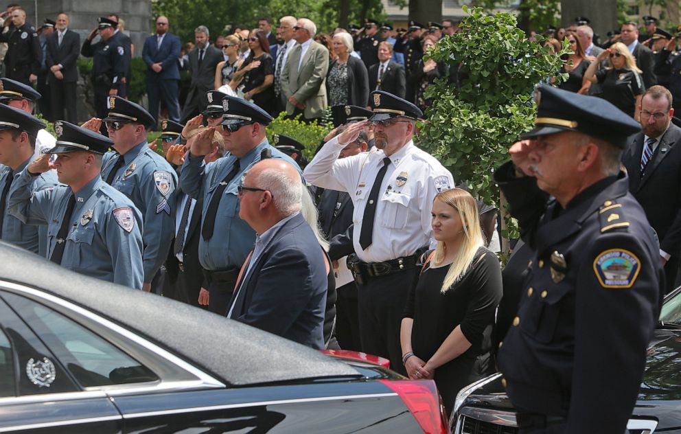 PHOTO: Hundreds of police officers stood at attention and saluted in front of the Cathedral Basilica of St. Louis as the body of officer Michael Langsdorf was taken from the church at the end of the funeral mass on July 1, 2019, in St. Louis.