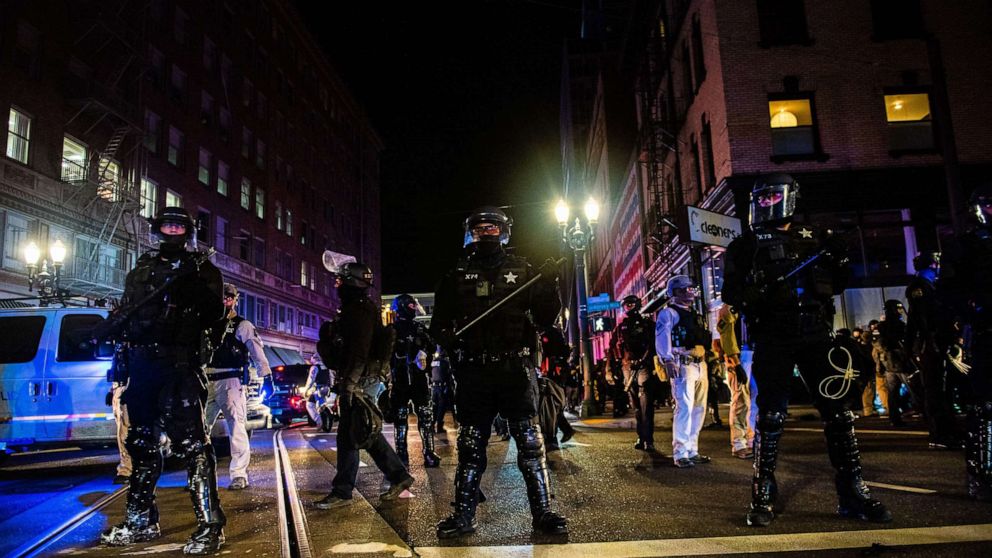 PHOTO: TOPSHOT - Oregon State Troopers block a street as they confront protesters in Portland, Oregon on November 4, 2020, during a demonstration called by the "Black Lives Matter" movement, a day after the US Presidential Election. 