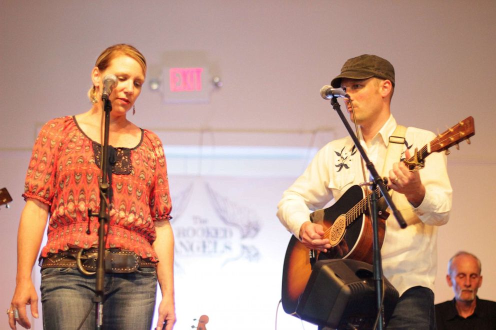 PHOTO: James and Amy Potter take a moment before performing at a party as The Crooked Angels.