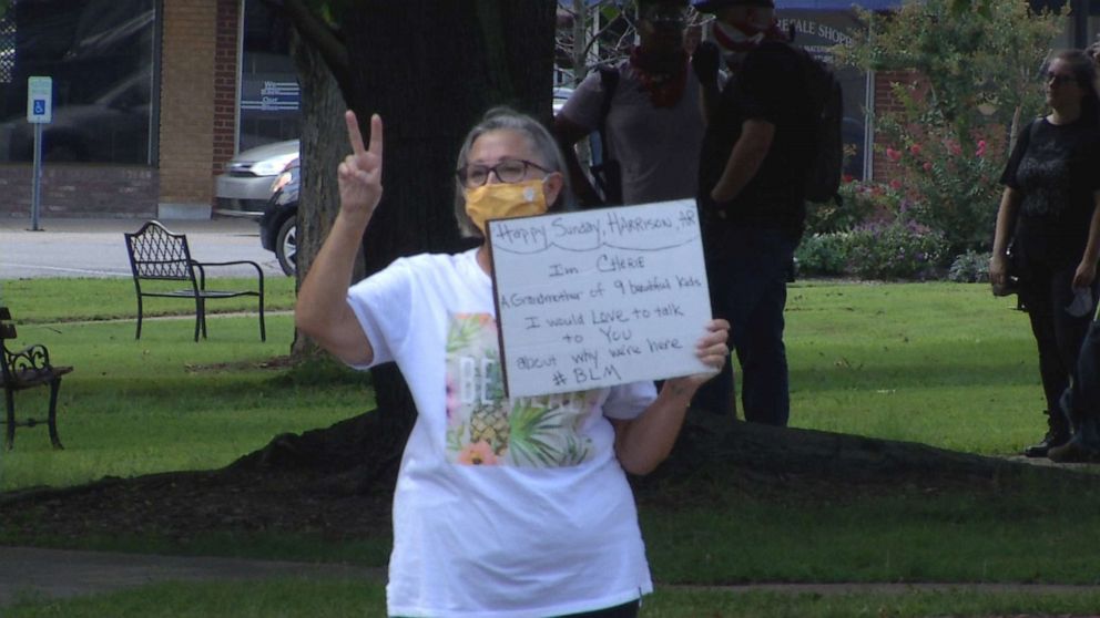 PHOTO: A Black Lives Matter demonstrator in Harrison, Arkansas, encourages passersby to talk engage in a discussion about racism.