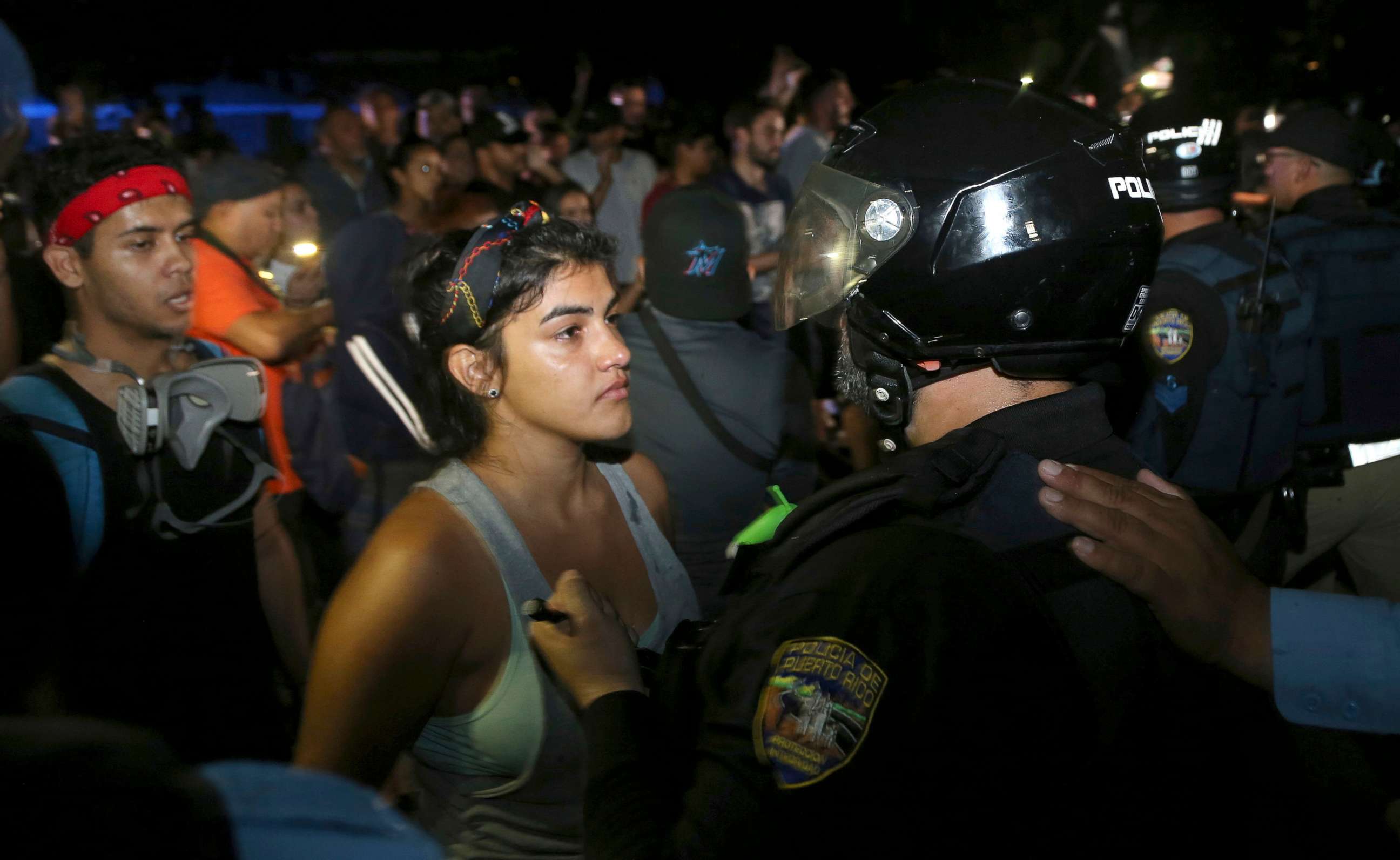 PHOTO: A protester confronts a police officer who is part of a battalion blocking the gate of the Yolanda Guerrero Cultural Center in Guaynabo, Puerto Rico, July 21, 2019.
