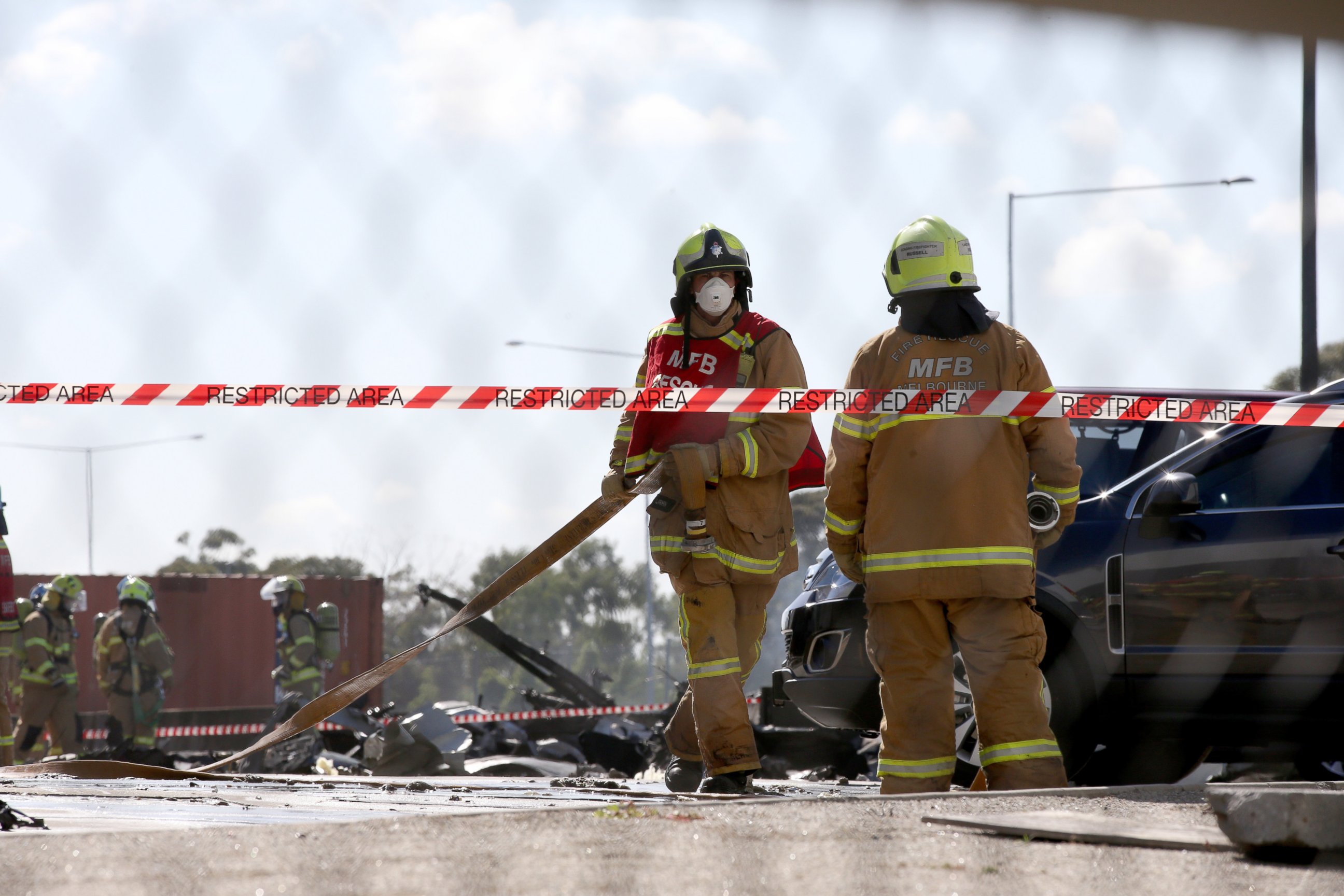 PHOTO: Firefighters on the scene after a light plane crashed into a DFO (Discount Factory Outlet) near Essendon Airport, in Melbourne, Australia, on Feb 21, 2017.