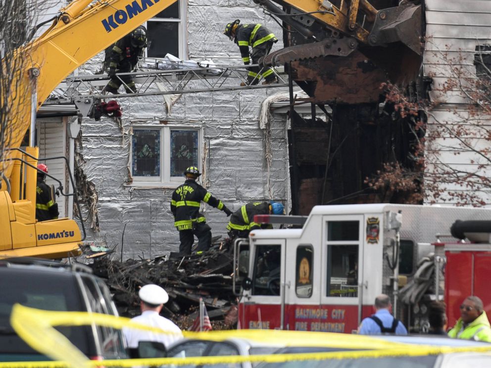 PHOTO: Officials remove a sheet covered stretcher from the scene of a overnight house fire where several children were presumed dead and others including the mother injured in Baltimore, Jan. 12, 2017.