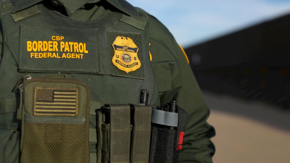 U.S. border patrol agent walks along the border fence separating Mexico from the United States near Calexico, California, Feb. 8, 2017.